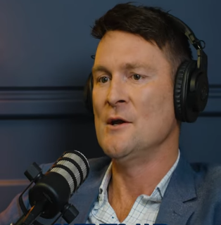 Corporate video production on the Gold Coast featuring a business professional speaking into a microphone during a podcast or interview recording.