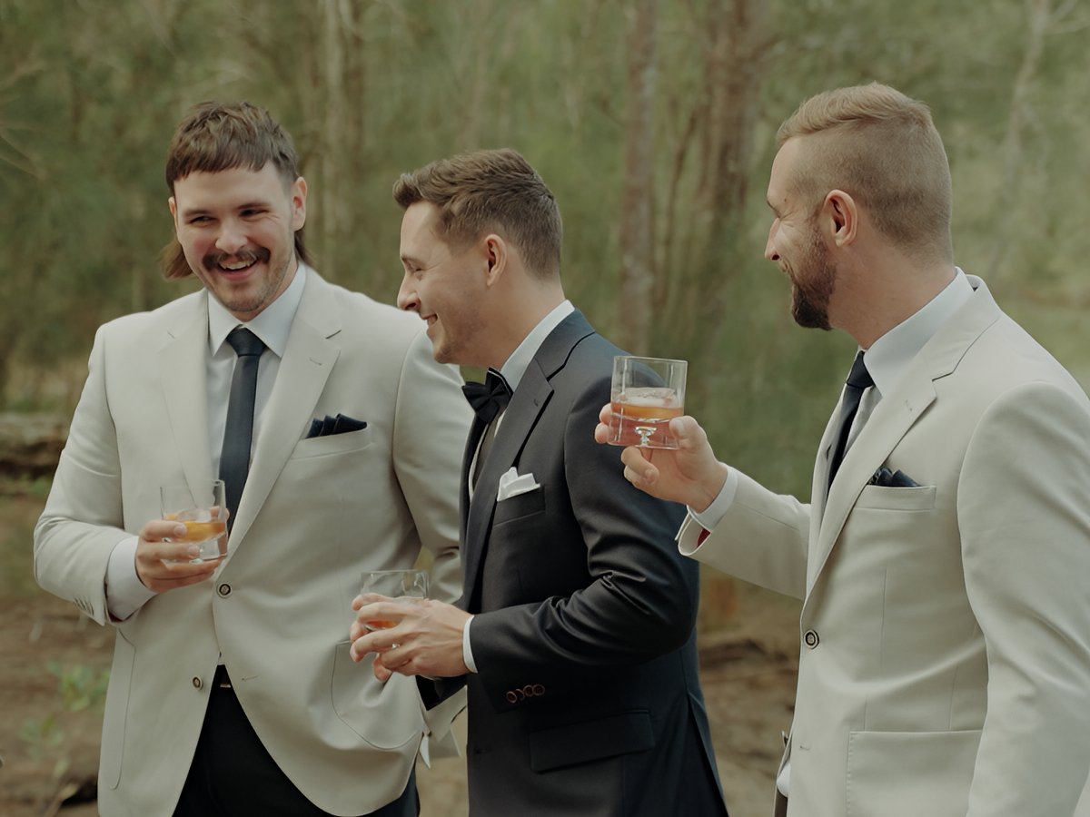 Corporate event videography on the Gold Coast capturing guests networking outdoors in formal attire during a stylish business celebration.